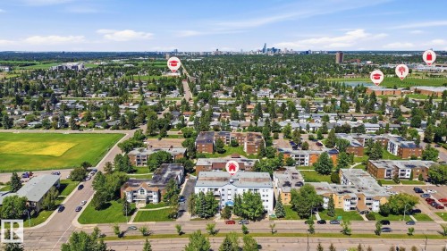 Aerial perspective showcasing a residential area with a mix of multi-story buildings and single-family homes - 105 11446 40 Avenue Nw, Edmonton, AB 