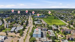 Aerial perspective of a developed urban area featuring a major thoroughfare and a mix of residential and commercial structures - 