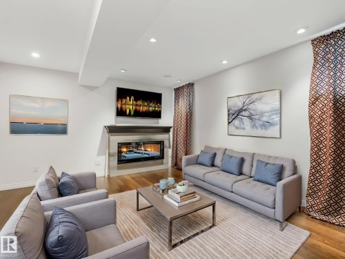 Second living room for entertaining in the basement has electric fireplace and TV can stay. - 14843 140 Street, Edmonton, AB 