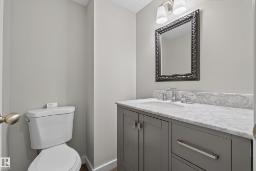 Modern vanity with gray cabinetry, brushed nickel hardware, and an integrated sink - 2712 104 Street, Edmonton, AB 