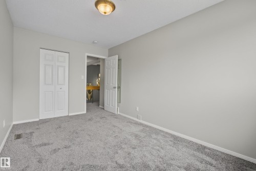 Neutral gray wall color with white trim and gray carpeting - 2712 104 Street, Edmonton, AB 