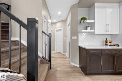 Modern staircase with dark wood-finish newel posts and metal balusters - 