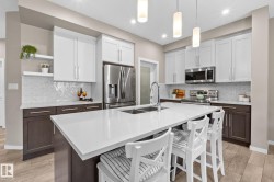 Modern kitchen featuring an expansive island with white countertop - 