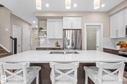 Kitchen island featuring a double-basin undermount sink with a gooseneck faucet - 