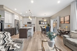 Open-concept interior featuring light wood-finish flooring throughout - 