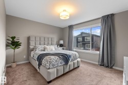 Plush carpeted bedroom with neutral wall tones - 