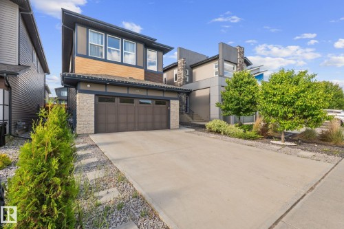 Contemporary exterior featuring multiple architectural styles and a concrete driveway - 2146 Koshal Way, Edmonton, AB 
