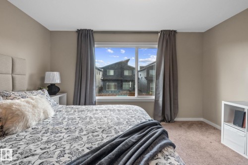Neutral-toned walls complement the carpeted flooring - 2146 Koshal Way, Edmonton, AB 