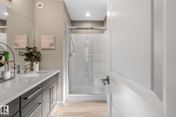 Shower stall featuring a glass enclosure and tiled surround - 