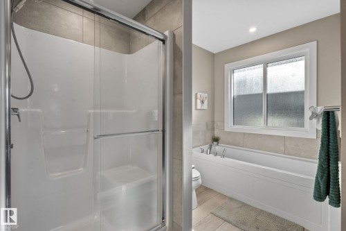 Contemporary bathroom featuring a combined shower and soaking tub - 2146 Koshal Way, Edmonton, AB 
