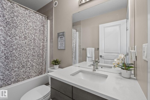 Modern vanity with an integrated sink and light-toned countertop - 2146 Koshal Way, Edmonton, AB 