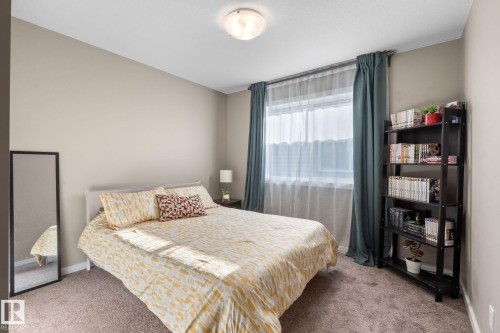 Carpeted room with a window featuring sheer and solid drapery - 2146 Koshal Way, Edmonton, AB 