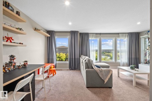 Expansive room featuring light-colored carpeting and recessed lighting - 2146 Koshal Way, Edmonton, AB 