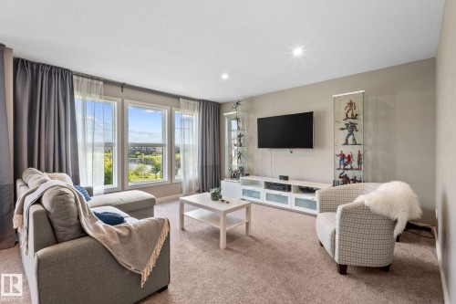 Living area with light beige carpet flooring and neutral wall tones - 2146 Koshal Way, Edmonton, AB 