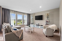 Living area with light beige carpet flooring and neutral wall tones - 