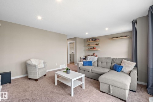 Inviting living area featuring recessed lighting, neutral wall tones, and plush carpet flooring - 2146 Koshal Way, Edmonton, AB 