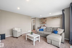 Inviting living area featuring recessed lighting, neutral wall tones, and plush carpet flooring - 