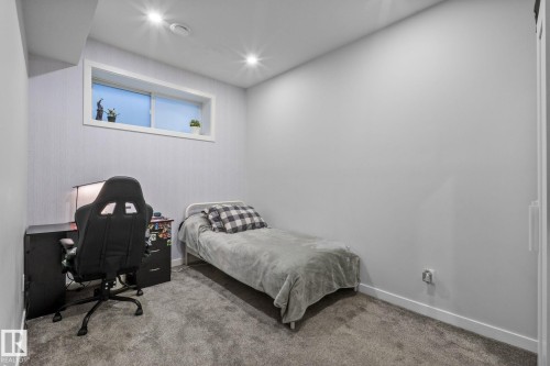 Carpeted room featuring a white-framed egress window and recessed lighting - 2146 Koshal Way, Edmonton, AB 