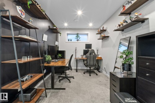 Dedicated workspace featuring two built-in desks, recessed lighting, and wall-mounted shelving - 2146 Koshal Way, Edmonton, AB 