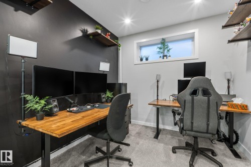Dedicated workspace featuring a plank wood-finish desktop, recessed ceiling lighting, and a horizontal window - 2146 Koshal Way, Edmonton, AB 