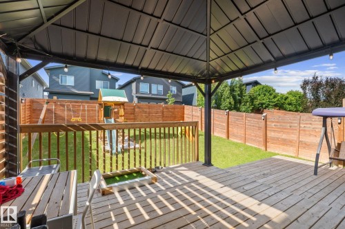 Expansive wooden deck with a built-in gazebo featuring string lighting - 2146 Koshal Way, Edmonton, AB 