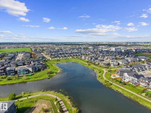 Expansive residential community featuring a prominent lake, extensive green spaces, and paved walking paths - 2146 Koshal Way, Edmonton, AB 