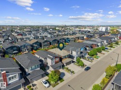 Contemporary residential property featuring a multi-story exterior with a two-car garage and a paved driveway - 