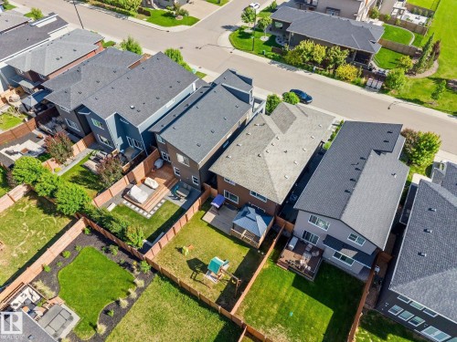 Aerial perspective of a residential street featuring multiple properties with distinct architectural styles - 2146 Koshal Way, Edmonton, AB 