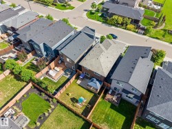Aerial perspective of a residential street featuring multiple properties with distinct architectural styles - 
