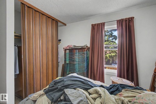 Wood-finish bifold closet doors with a coordinating wood header - 18409 66 Avenue, Edmonton, AB 