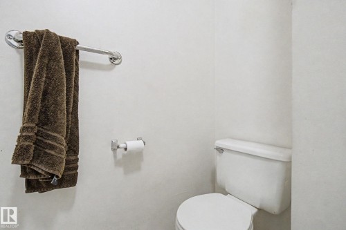 White wall paneling with a chrome towel bar and toilet paper holder - 18409 66 Avenue, Edmonton, AB 