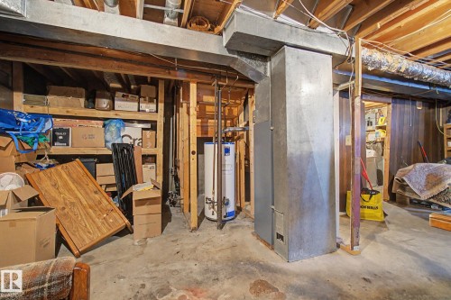 Unfinished basement space with exposed wood joists and concrete flooring - 18409 66 Avenue, Edmonton, AB 