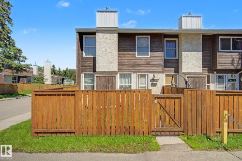 Townhouse exterior with wood-finish siding and stucco accents - 18409 66 Avenue, Edmonton, AB 