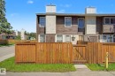 Townhouse exterior with wood-finish siding and stucco accents - 18409 66 Avenue, Edmonton, AB 