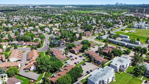 Expansive aerial view of a residential area featuring detached homes and multi-unit dwellings - 18409 66 Avenue, Edmonton, AB 