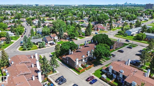 Aerial perspective showcasing a residential neighborhood with a distant cityscape - 18409 66 Avenue, Edmonton, AB 