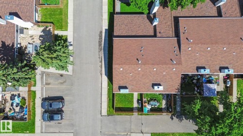 Aerial perspective showcasing multiple properties with brown shingle roofing - 18409 66 Avenue, Edmonton, AB 