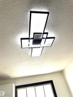Modern geometric ceiling light fixture with integrated fan - 