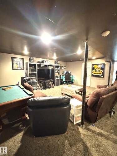 Recreation room featuring recessed lighting, a built-in entertainment center, and carpeted flooring - 45 Lambert Crescent, St. Albert, AB 