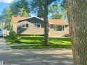 Property exterior featuring horizontal siding, a gabled roofline, and a concrete driveway - 45 Lambert Crescent, St. Albert, AB 