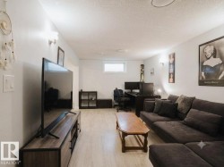 Spacious room featuring light-toned wood-finish flooring and neutral wall tones - 