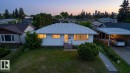 Single-story residence featuring a metal roof, white siding, and a covered carport - 7515 130 Avenue, Edmonton, AB 