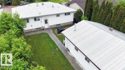 Two structures with white siding and metal roofs - 