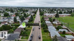 Residential street featuring single-story homes with mature landscaping - 