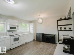 Contemporary kitchen space featuring wood-finish flooring - 