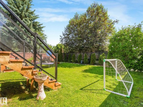 Expansive green lawn with mature trees and perimeter fencing - 2035 49A Street, Edmonton, AB 