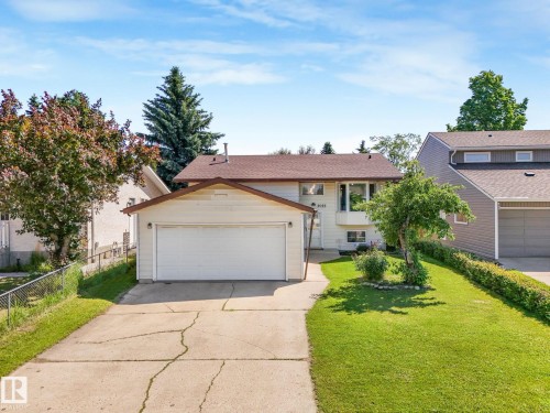 Split-level residence featuring a two-car garage, bay window, and gabled roofline - 2035 49A Street, Edmonton, AB 