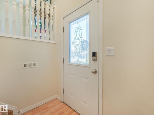 Entry door with decorative glass insert and smart lock - 2035 49A Street, Edmonton, AB 