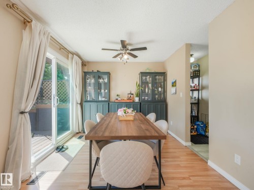 Dining space with wood-finish flooring and a ceiling fan - 2035 49A Street, Edmonton, AB 