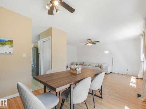 Light wood-finish flooring extending through the living area - 2035 49A Street, Edmonton, AB 